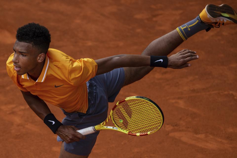 Felix Auger-Aliassime, from Canada, serves to Rafael Nadal, from Spain, during the Madrid Open tennis tournament in Madrid, Wednesday, May 8, 2019. (AP Photo/Bernat Armangue)