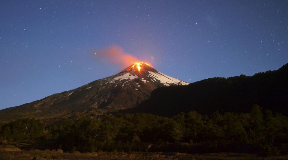 Ash and lava spew from the Villarrica volcano, as seen from Pucon town in the south of Santiag