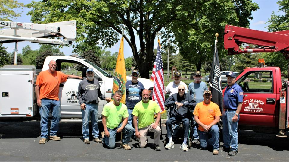 Members of Vietnam Veterans of America Chapter #1117 and employees of the City of Marion gathered for a photo on Tuesday, May 24, 2022, at Veterans Memorial Park after the city employees installed more of the banners honoring local veterans. The banners are displayed around the city.