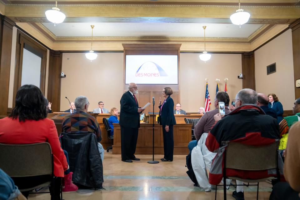 Connie Boesen is sworn in as Des Moines Mayor by her husband Ted Bosen before at city council meeting, Monday, Jan. 8, 2024.