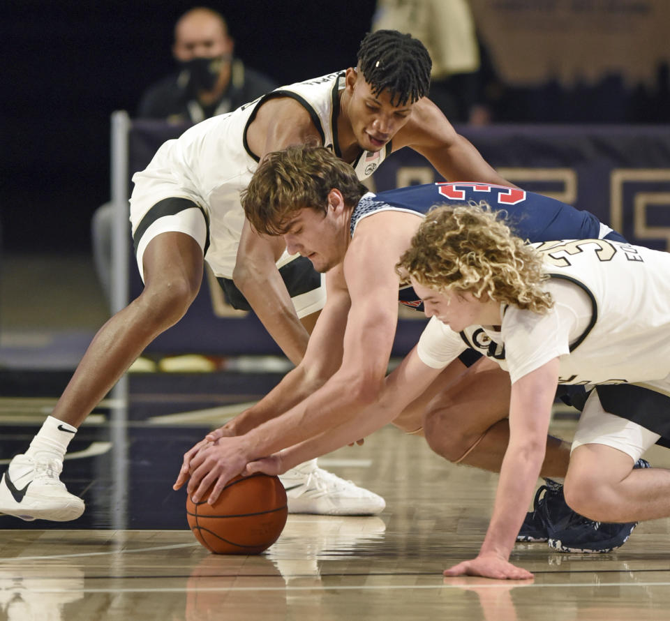 Wake Forest's Carter Whitt, right, and Ody Oguama, top, battle for the ball with Catawba's Ben Bowen during an NCAA college basketball game, Thursday, Dec. 31, 2020, at Joel Coliseum in Winston-Salem, N.C. (Walt Unks//The Winston-Salem Journal via AP)