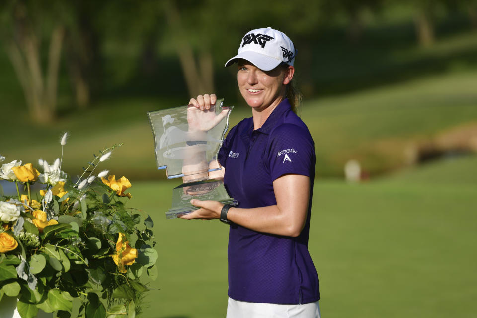 Austin Ernst holds the championship trophy after winning the LPGA Walmart NW Arkansas Championship golf tournament, Sunday, Aug. 30, 2020, in Rogers, Ark. (AP Photo/Michael Woods)