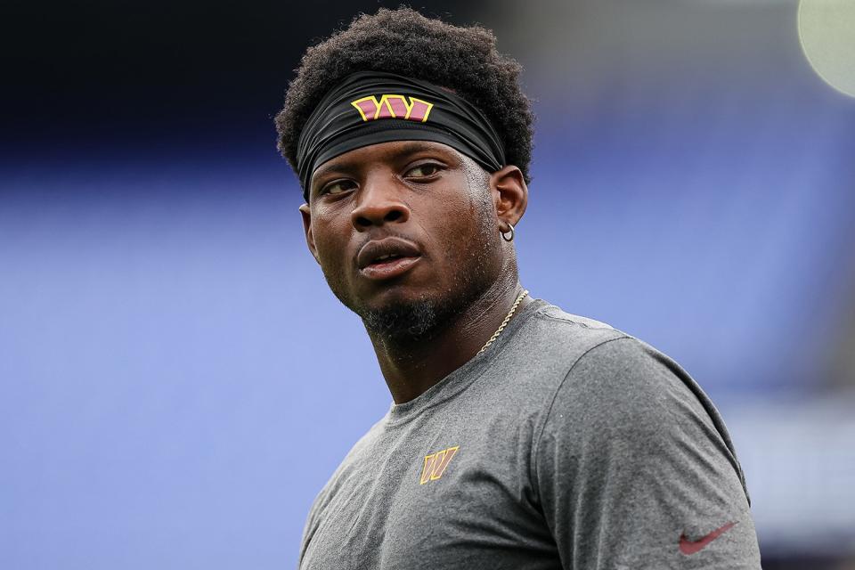 Brian Robinson #8 of the Washington Commanders warms up before the preseason game against the Baltimore Ravens