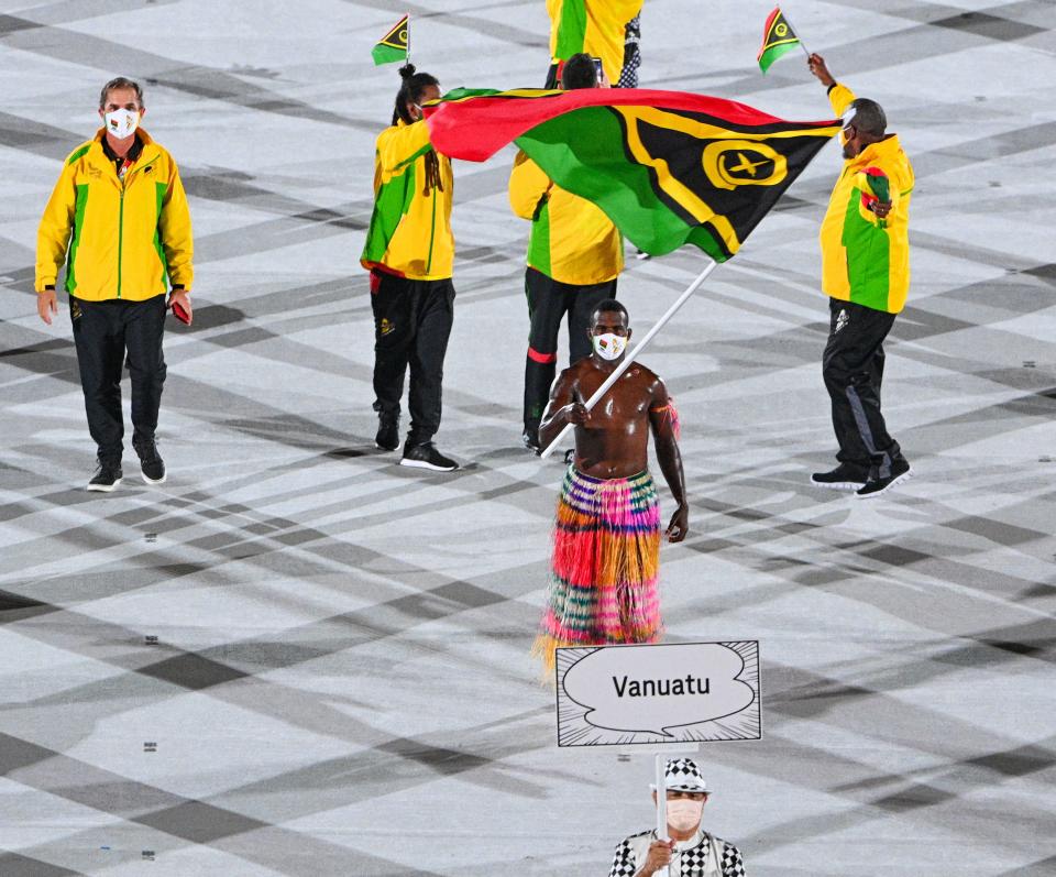 Vanautu's flag bearer Riilio Rii leads the delegation during the opening ceremony of the Tokyo 2020 Olympic Games, at the Olympic Stadium, in Tokyo, on July 23, 2021. (Photo by Martin BUREAU / AFP) (Photo by MARTIN BUREAU/AFP via Getty Images)