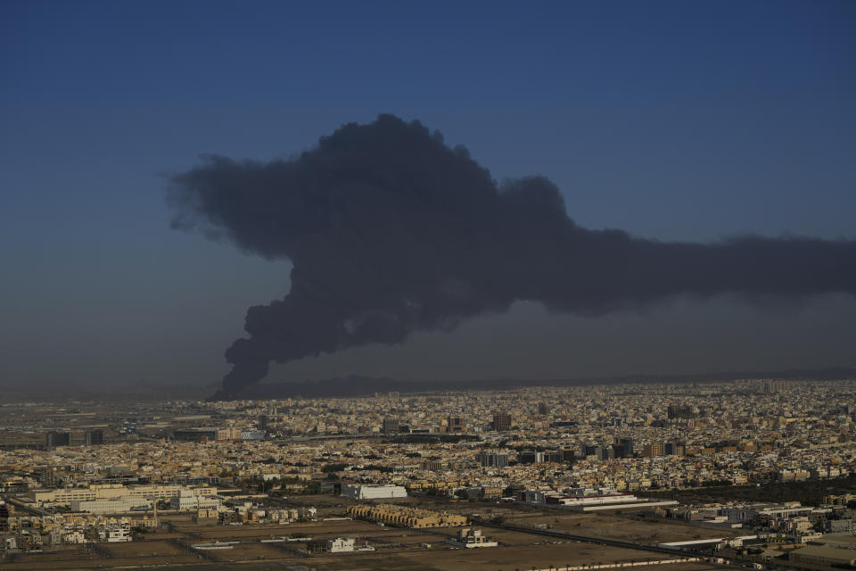 A cloud of smoke rises from a burning oil depot in Jiddah, Saudi Arabia, Friday, March 25, 2022. (AP Photo/Hassan Ammar)