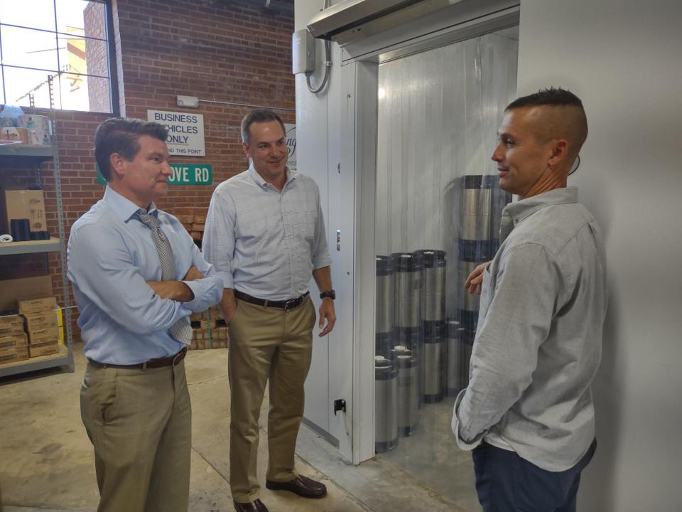 Rep. Richard Hudson (middle) discusses economic development and the redrawing of U.S. congressional districts during a visit to Goose and the Monkey Brewhouse on Wednesday. Also pictured are Lexington Mayor Newell Clark (left) and Brent Moore, owner of Goose and the Monkey.
