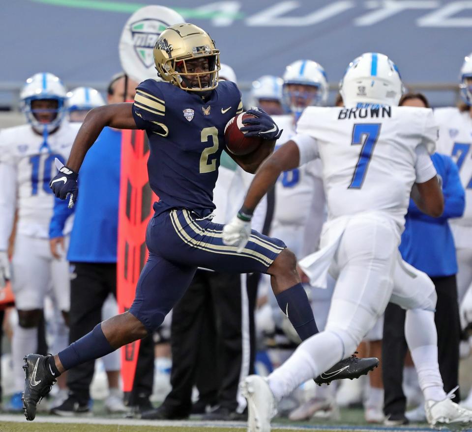 Akron Zips running back Anthony Williams Jr. (2) rushes down the sideline past Buffalo Bulls safety E.J. Brown (7) during the second half of an NCAA college football game, Saturday, Oct. 23, 2021, in Akron, Ohio.