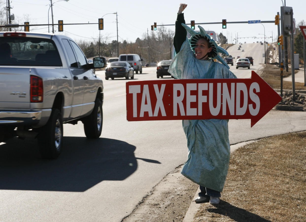 Shannon Philbrick of Liberty Tax Services, dressed as the Statue of Liberty, encourages customers to come into the tax office to have their taxes prepared. (REUTERS/Rick Wilking)