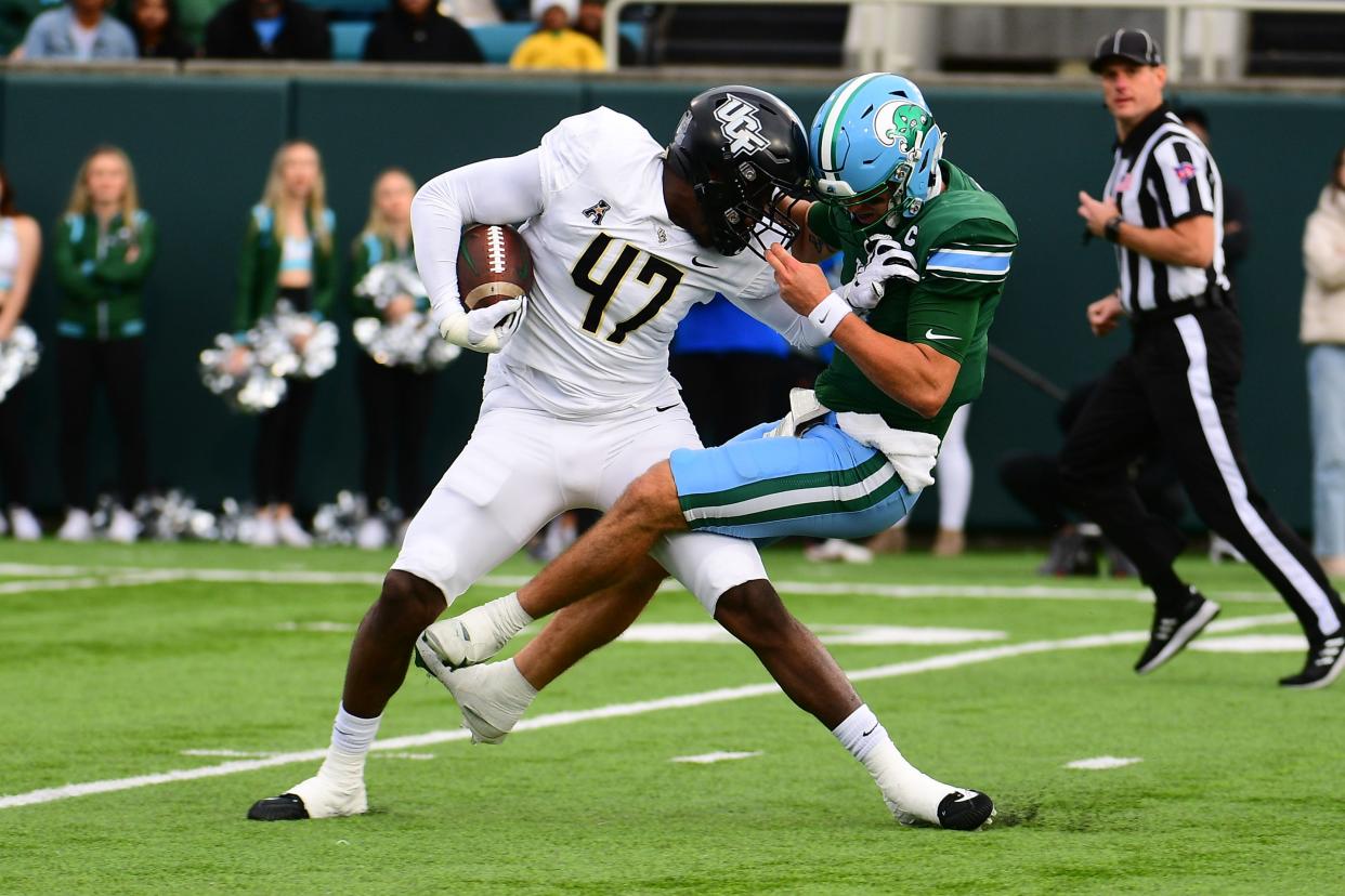 Nov 12, 2022; New Orleans, Louisiana, USA; UCF Knights defensive end K.D. McDaniel (47) breaks away from Tulane Green Wave quarterback Michael Pratt (7) following an interception during the first quarter at Yulman Stadium. Mandatory Credit: Rebecca Warren-USA TODAY Sports