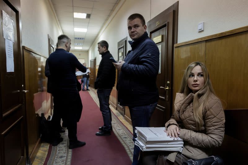 People wait in a corridor at the Pecherskyi District Court of Kyiv City in Kyiv