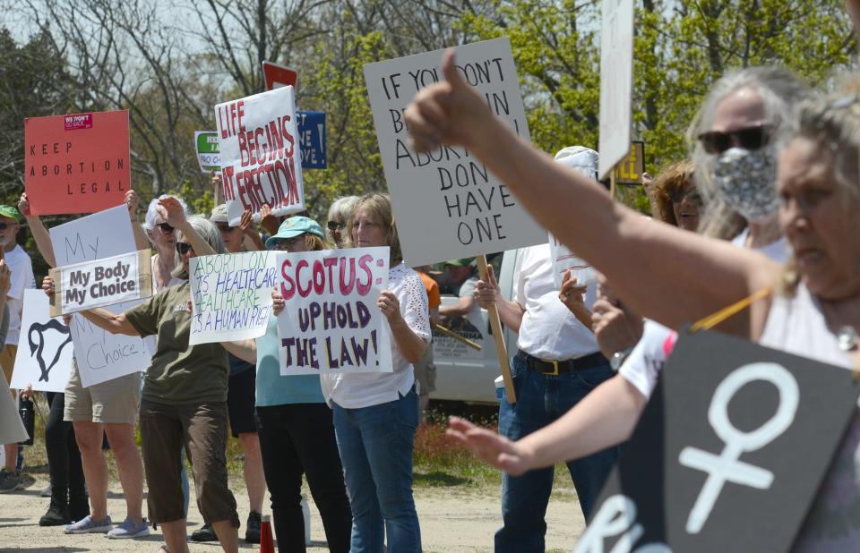 Demonstrators ring the edge of the Orleans Rotary on Saturday afternoon where a large group gathered in support of abortion rights as part as nationwide protests over a leaked Supreme Court draft opinion that calls for overturning Roe v. Wade that established the right to legal abortion. Steve Heaslip/Cape Cod Times