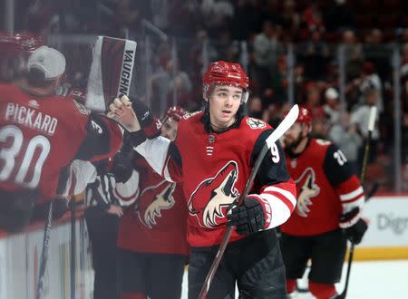 Jan 18, 2019; Glendale, AZ, USA; Arizona Coyotes center Clayton Keller (9) celebrates with teammates after scoring after a goal against the Pittsburgh Penguins in the first period at Gila River Arena. Mandatory Credit: Mark J. Rebilas-USA TODAY Sports