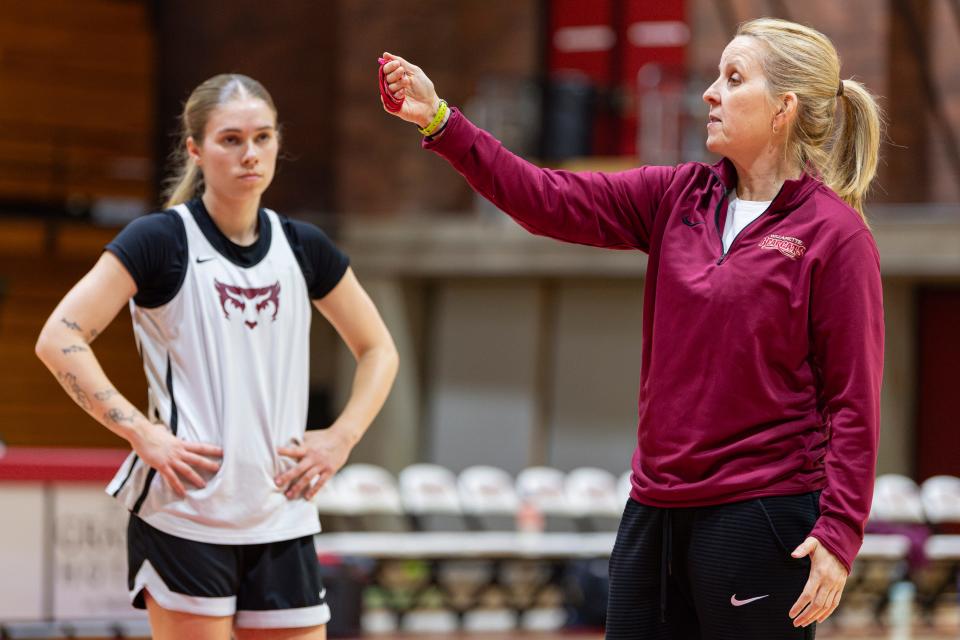 Willamette head coach Peg Swadener speaks to the team during practice at Cone Field House on Wednesday.