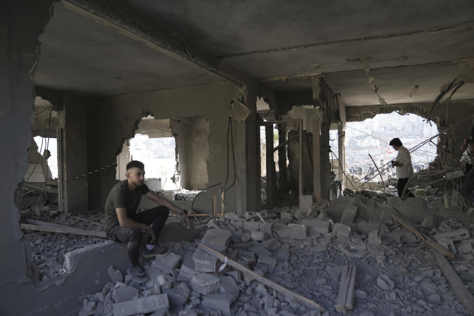 Palestinians clear rubble after Israeli forces demolished the home of Osama Tawil, who was arrested in February for killing an Israeli soldier last year, in Nablus, Thursday, June 15, 2023. During the demolition operation, the Israeli military said troops operating in Nablus came under fire and fired back. A Palestinian man was killed, health officials said. (AP Photo/Nasser Nasser)