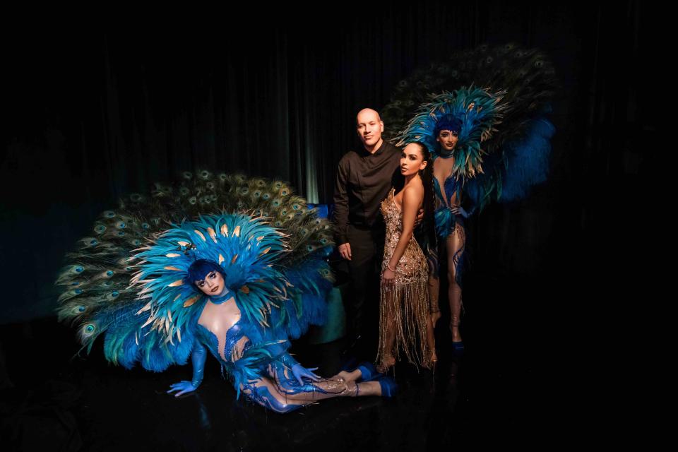 Afrika Chao pictured in her third custom-made dress with husband Anthony Osorio and two 'peacock' dancers. (Michael Anthony Studios)