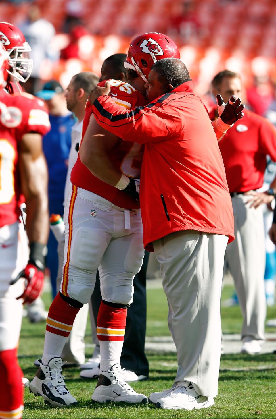 KANSAS CITY, MO - DECEMBER 02: Head coach Romeo Crennel of the Kansas City Chiefs receives a hug from center Ryan Lilja #65 during player warm-ups prior to the game against the Carolina Panthers at Arrowhead Stadium on December 2, 2012 in Kansas City, Missouri. (Photo by Jamie Squire/Getty Images)