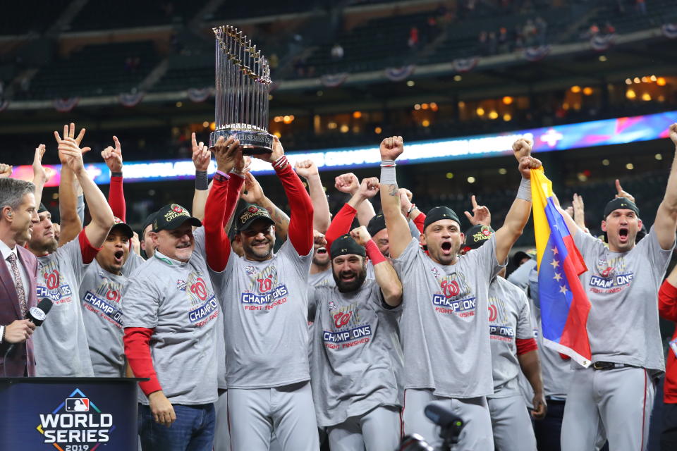 HOUSTON, TX - OCTOBER 30: Washington Nationals general manager Mike Rizzo and manager Dave Martinez #4 hold up the World Series trophy after the Nationals defeat the Houston Astros in Game 7 to win the 2019 World Series at Minute Maid Park on Wednesday, October 30, 2019 in Houston, Texas. (Photo by Alex Trautwig/MLB Photos via Getty Images)