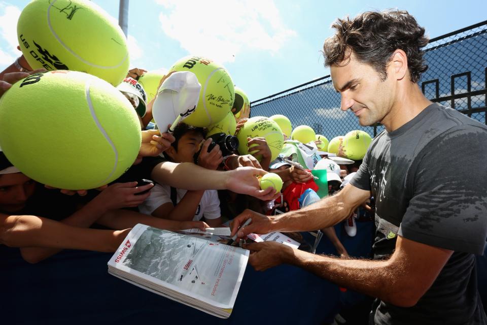 Federer signs autographs after practice Thursday at the U.S. Open (Photo by Mike Stobe/Getty Images for USTA)