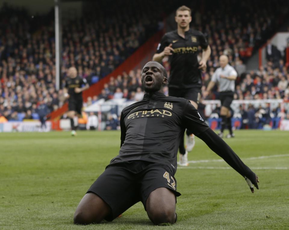 Manchester City's Yaya Toure celebrates after he scores a goal during the English Premier League soccer match between Crystal Palace and Manchester City at Selhurst Park stadium in London, Sunday, April 27, 2014. (AP Photo/Kirsty Wigglesworth)