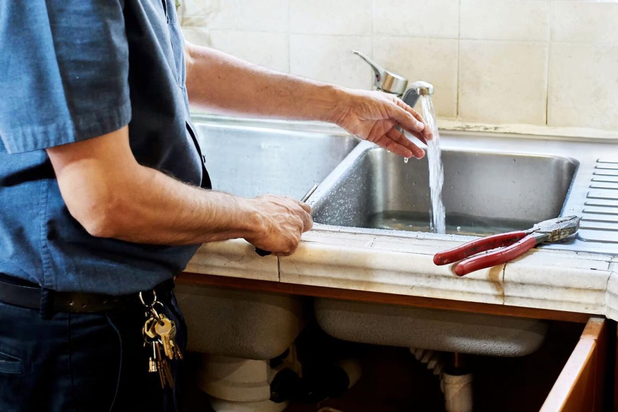 plumber fixing faucet