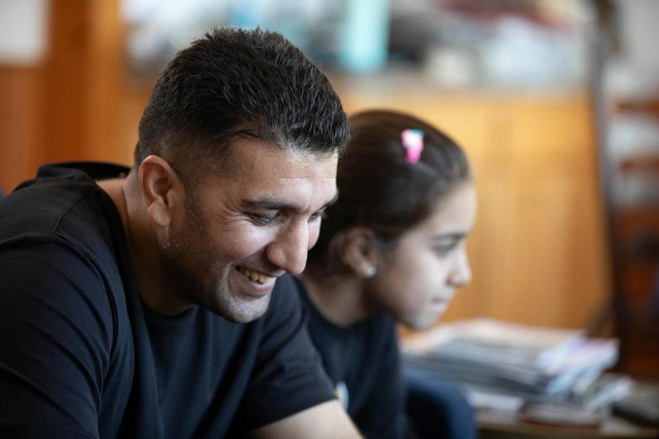 Kawa Barakazai shares a light moment with daughter Maryam in their new Cambria home. The Barakazai family spent more than two years in hiding in Afghanistan and Pakistan before arriving in the United States on Sept. 6, 2023.