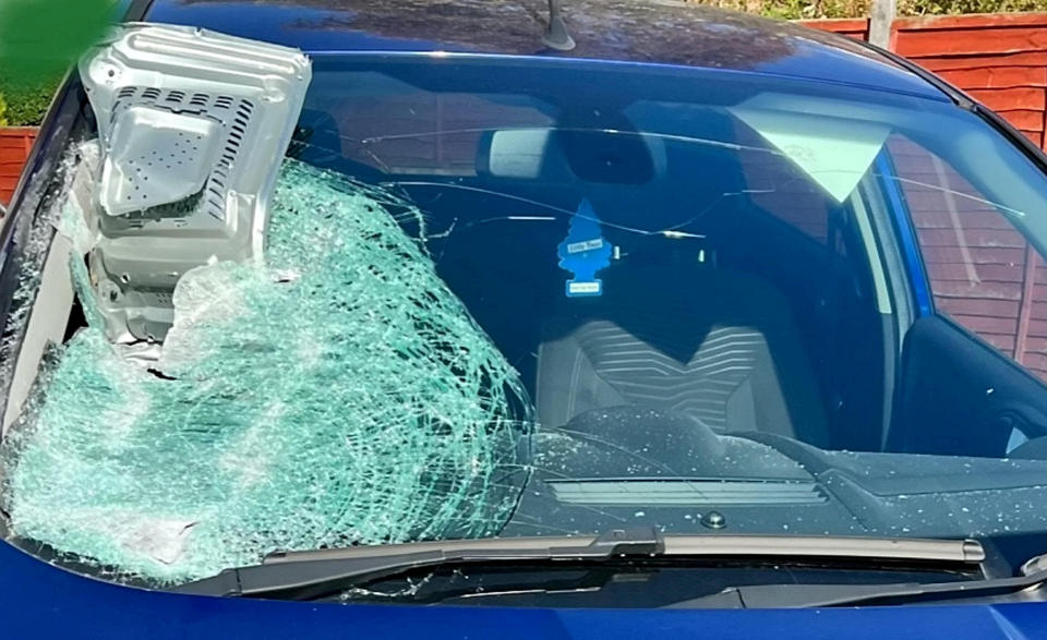 Police are investigating after a microwave was thrown at the windscreen of a moving car. (SWNS)