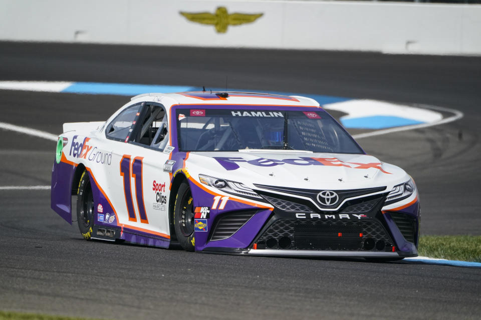 Denny Hamlin (11) drives through a turn during practice for the NASCAR Cup Series auto race at Indianapolis Motor Speedway in Indianapolis, Saturday, Aug. 14, 2021. (AP Photo/Michael Conroy)