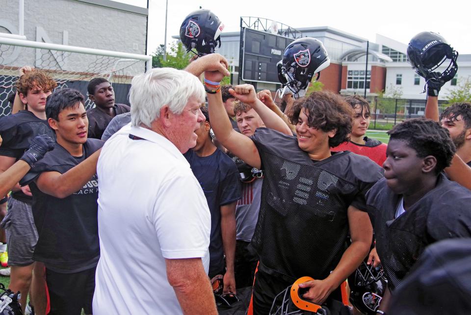 Stoughton varsity football Coach Greg Burke brings practice on Friday, August 26, 2022, to a close with the traditional Black Knights team slogan, 1-2-3 Hammer! Stoughton is scheduled to play Taunton High School in a scrimmage the next day.