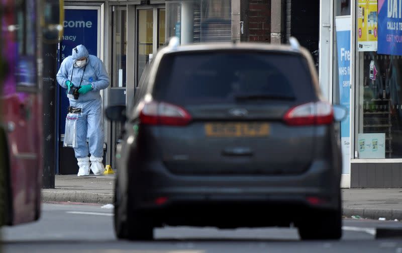 Police forensic officer works near the site where a man was shot by armed officers in Streatham, south London