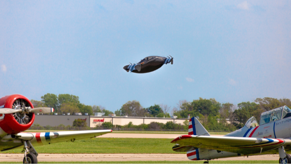 UFO in a WWII movie? No, that’s just Blackfly at AirVenture flying above two vintage fighter planes. - Credit: Courtesy Opener, LLC