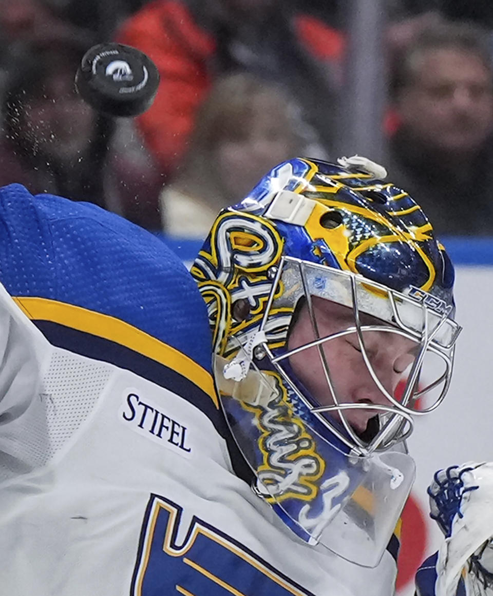 St. Louis Blues goalie Joel Hofer makes a save against the Vancouver Canucks during the first period of an NHL hockey game Wednesday, Jan. 24, 2024, in Vancouver, British Columbia. (Darryl Dyck/The Canadian Press via AP)