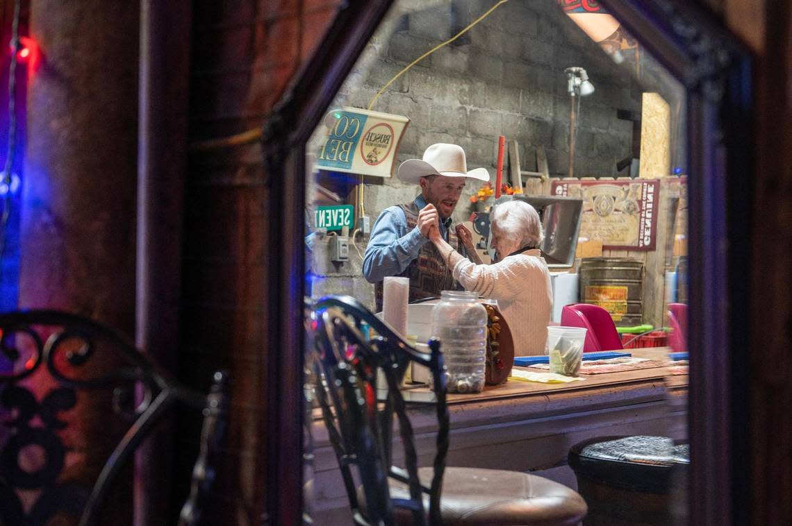 Ty Gable, left, dances with his grandmother Faye Dunbar in between serving drinks to customers at the show.