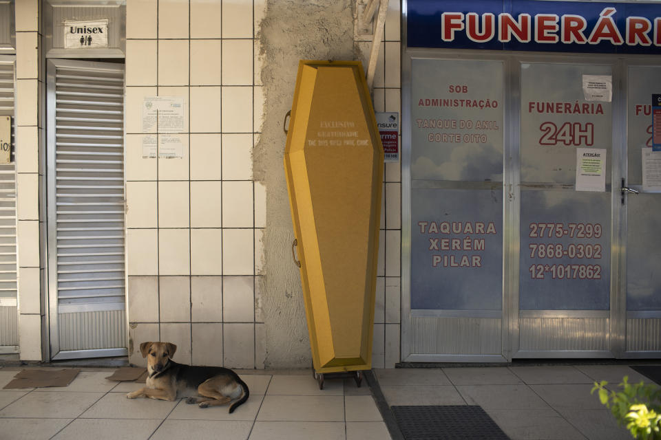 An empty coffin stands against the wall at the entrance of a funeral home during the COVID-19 pandemic at the Nossa Senhora das Gracas cemetery in Duque de Caxias, Rio de Janeiro, Brazil, Monday, April 27, 2020. Cases of the new coronavirus are overwhelming hospitals, morgues and cemeteries across Brazil as Latin America’s largest nation veers closer to becoming one of the world’s pandemic hot spots. (AP Photo/Silvia Izquierdo)