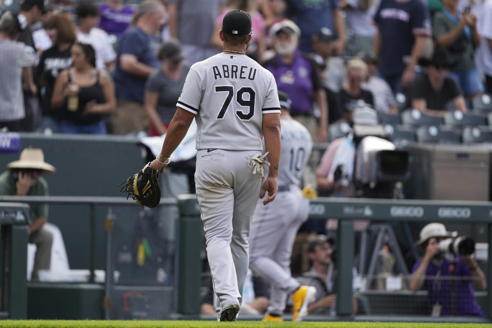 Chicago White Sox first baseman Jose Abreu, front, and third baseman Yoan Moncada head to the dugout after Colorado Rockies' Elias Diaz singled in the trying and winning runs in the ninth inning of a baseball game Wednesday, July 27, 2022, in Denver. (AP Photo/David Zalubowski)