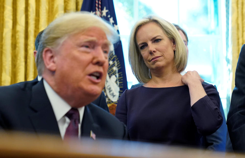 President Donald Trump talks to reporters as Department of Homeland Security Secretary Kirstjen Nielsen (R) looks on at a signing ceremony for the Cybersecurity and Infrastructure Security Agency Act in the Oval Office of the White House, November 16, 2018. REUTERS/Jonathan Ernst