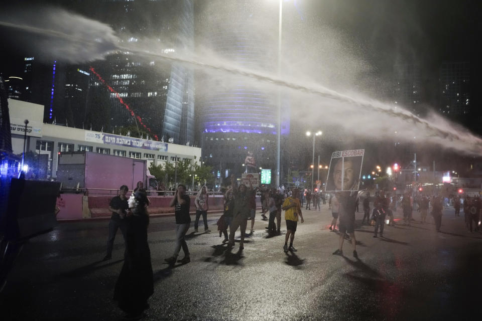 Police use water cannon to disperse demonstrators during a protest against Israeli Prime Minister Benjamin Netanyahu's government, and calling for the release of hostages held in the Gaza Strip by the Hamas militant group, in Tel Aviv, Israel, Saturday, May 18, 2024. (AP Photo/Leo Correa)