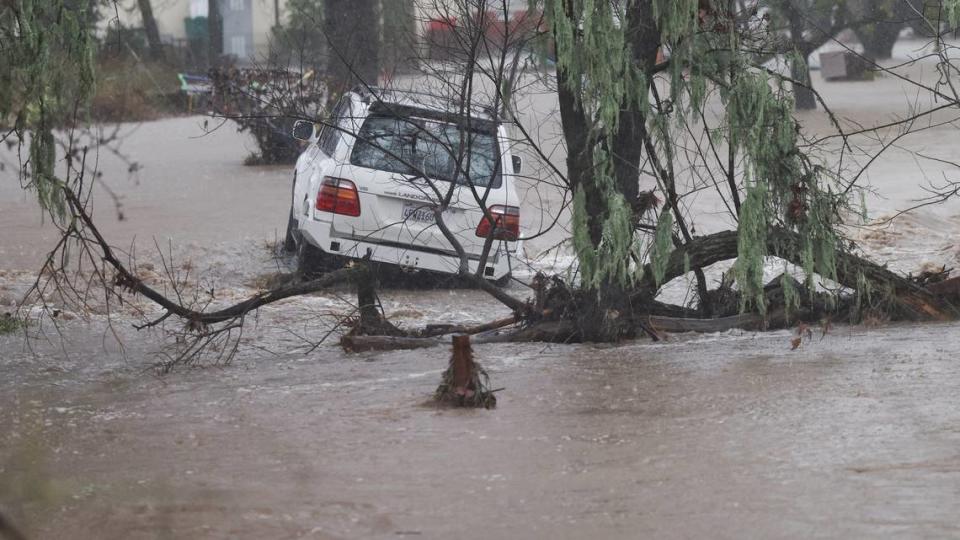 A car stuck in an overflowing Atascadero Creek was abandoned near Portola Road.