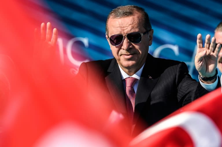 Turkish President Recep Tayyip Erdogan waves to supporters on August 26, 2016 in Istanbul during the inauguration of a bridge