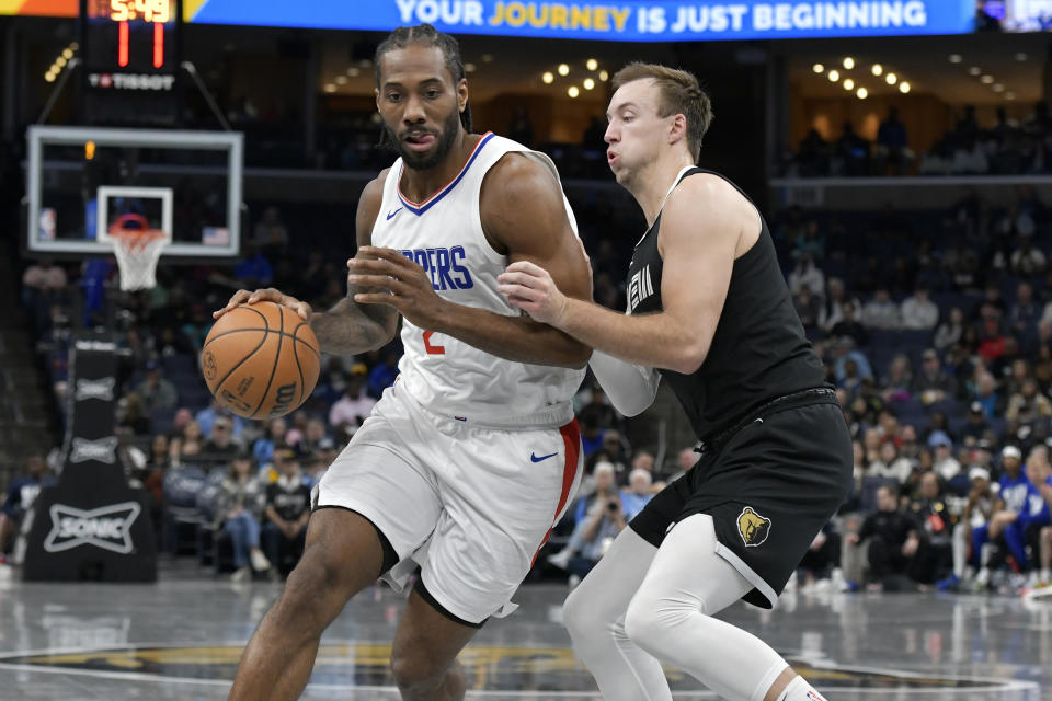 Los Angeles Clippers forward Kawhi Leonard (2) is defended by Memphis Grizzlies guard Luke Kennard during the first half of an NBA basketball game Friday, Feb. 23, 2024, in Memphis, Tenn. (AP Photo/Brandon Dill)