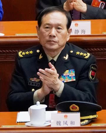 Newly elected Defense Minister Wei Fenghe claps at the seventh plenary session of the National People's Congress (NPC) at the Great Hall of the People in Beijing, China March 19, 2018. REUTERS/Jason Lee/Files