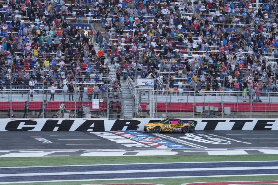 Oct 9, 2022; Concord, North Carolina, USA; NASCAR Cup Series driver Christopher Bell (20) takes the checkered flag to win the Bank of America ROVAL 400 at Charlotte Motor Speedway Road Course.
