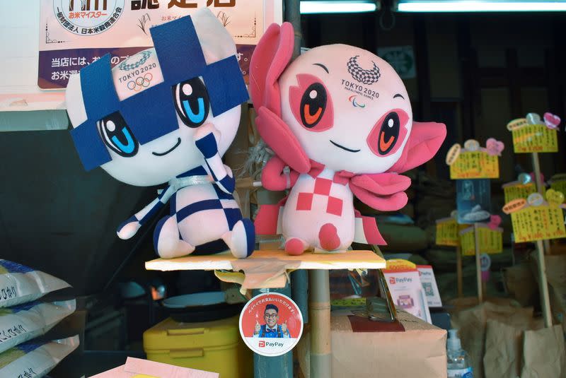 Tokyo 2020 mascots and PayPay app sticker are displayed at rice dealer's shop in Tokyo