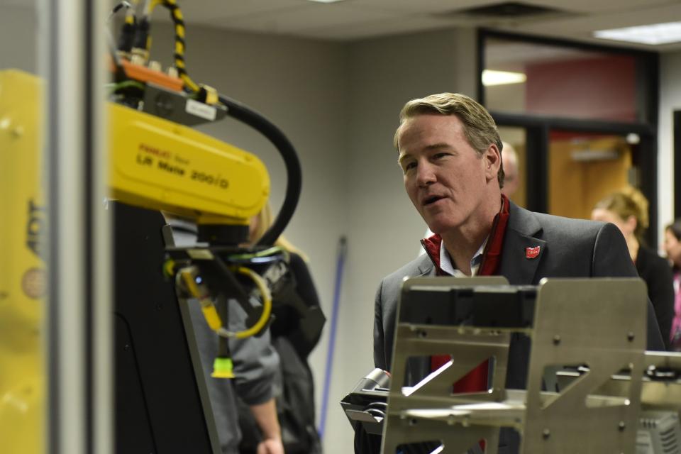 Ohio Lt. Gov. Jon Husted studies a piece of robotic equipment Friday on the campus of OSU-Mansfield.