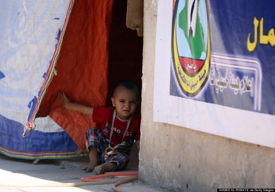 An Iraqi Turkman Shiite child displaced from the northern Iraqi area of Tal Afar takes shelter in a school in Sadr City, Baghdad, on August 5, 2014. (AHMAD AL-RUBAYE/AFP/Getty Images)