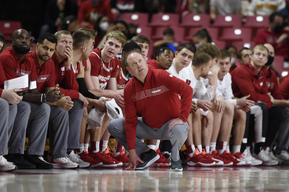 Wisconsin head coach Greg Gard, center, looks at the scoreboard as Maryland takes the lead in the second half of an NCAA college basketball game on Sunday, Jan. 9, 2022, in College Park, Md. (AP Photo/Gail Burton)