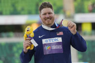 Gold medalist Ryan Crouser, of the United States, poses for a photo on the podium after the men's shot put final at the World Athletics Championships on Sunday, July 17, 2022, in Eugene, Ore. (AP Photo/David J. Phillip)