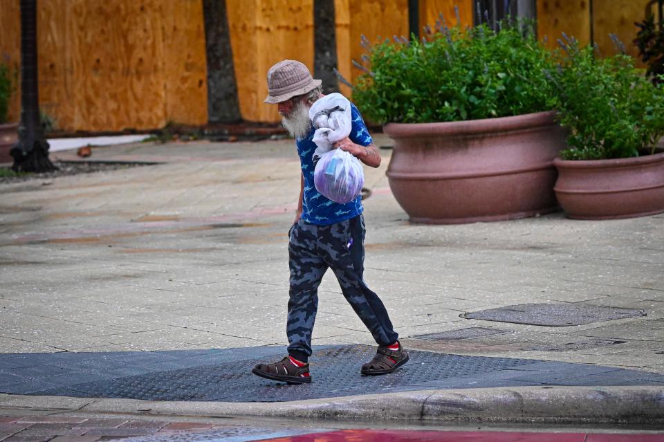 A homeless man loks for shelter in Tampa, Fla., on Aug. 30, 2023, after Hurricane Idalia made landfall.