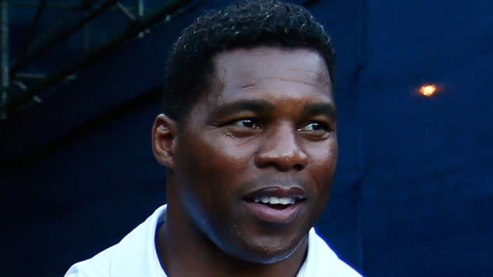 This 2014 photo shows former NFL star Herschel Walker walking onto Stadium Court for BB&T Atlanta Open at Atlantic Station. A third woman has emerged with claims that he threatened and stalked her. (Photo by Kevin C. Cox/Getty Images)