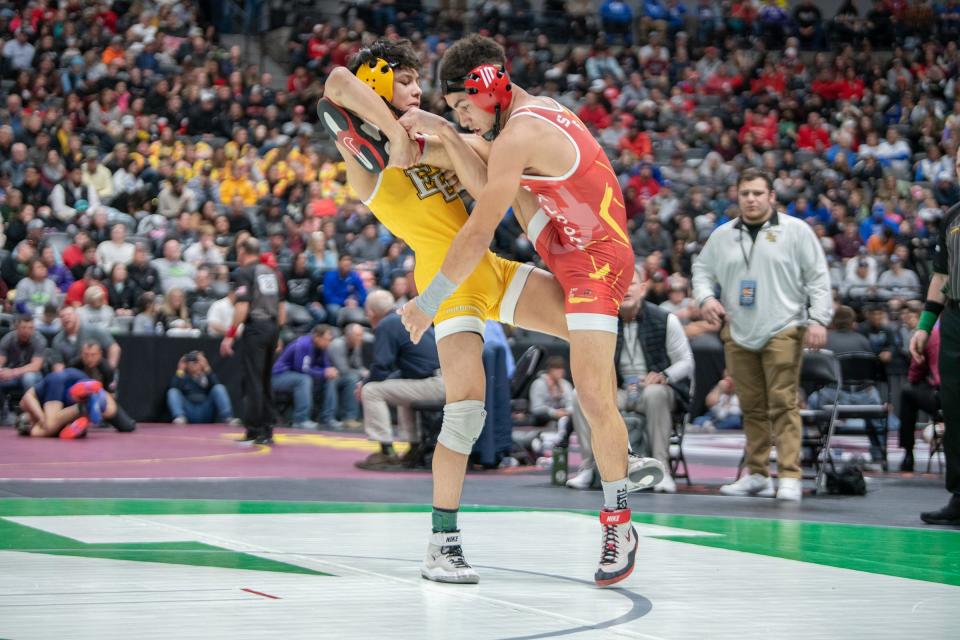 Pueblo East's Deven Lopez trips up Tobias Pinson of Skyline during their Class 4A 126-pound semifinal matchup on day two of the CHSAA state wrestling tournament on Friday, February 16, 2024.