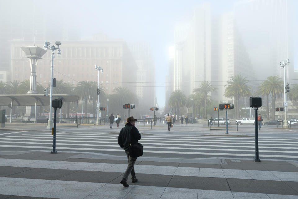 A man walks out of the Ferry Building to a near empty Embarcadero Thursday, March 12, 2020, in San Francisco. The area is normally filled with morning commuters. Gov. Gavin Newsom has issued sweeping, statewide "guidance" in response to the coronavirus pandemic, asking Californians to postpone all non-essential gatherings through the end of March, including even small social gatherings in places where people can't remain at least six feet apart. The vast majority of people recover from the new coronavirus. According to the World Health Organization, most people recover in about two to six weeks, depending on the severity of the illness. (AP Photo/Eric Risberg)